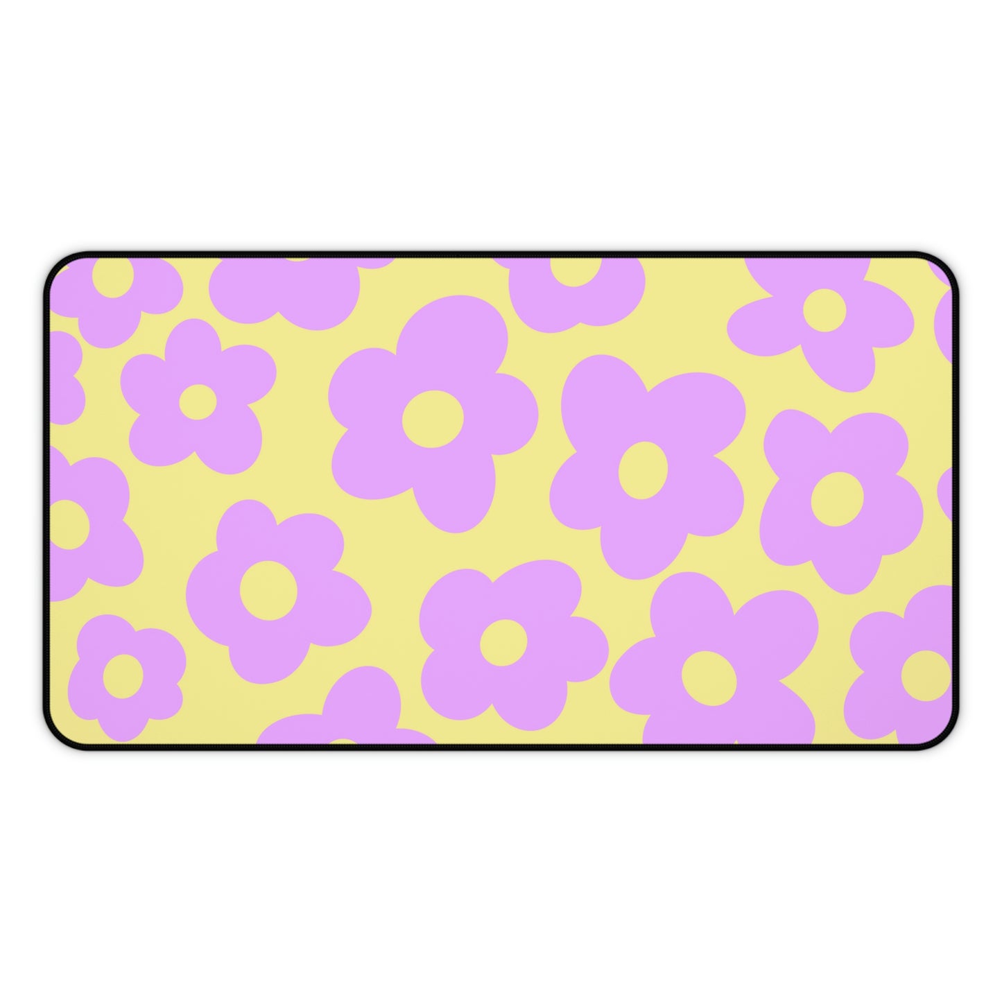 A 12" x 22" desk mat with purple flowers on a yellow background.