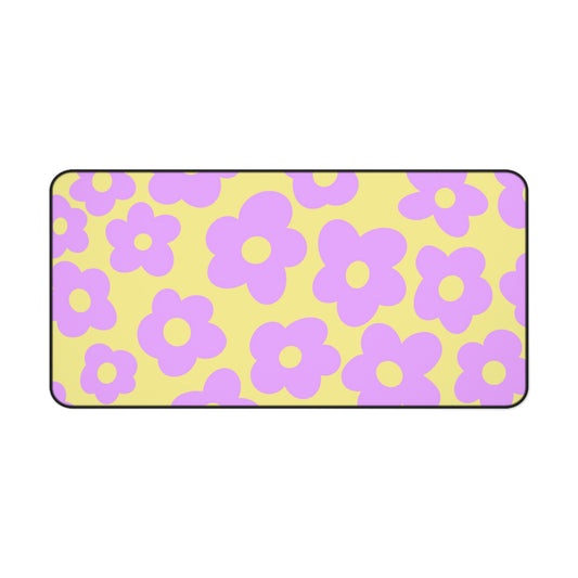 A 31" x 15.5" desk mat with purple flowers on a yellow background.