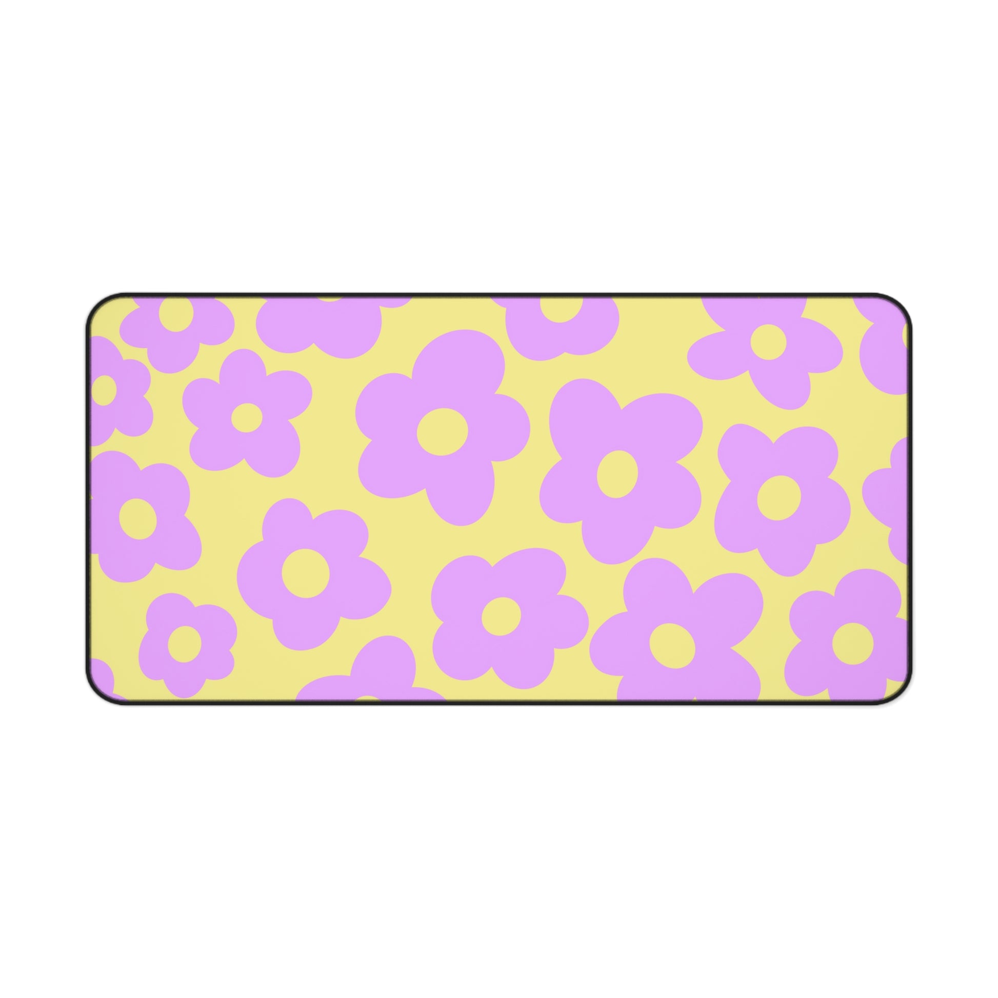 A 31" x 15.5" desk mat with purple flowers on a yellow background.