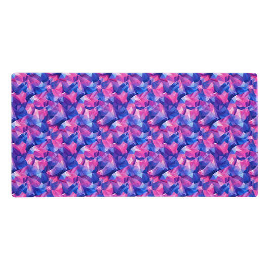 A 36" x 18" gaming desk pad with pink and blue crystals.