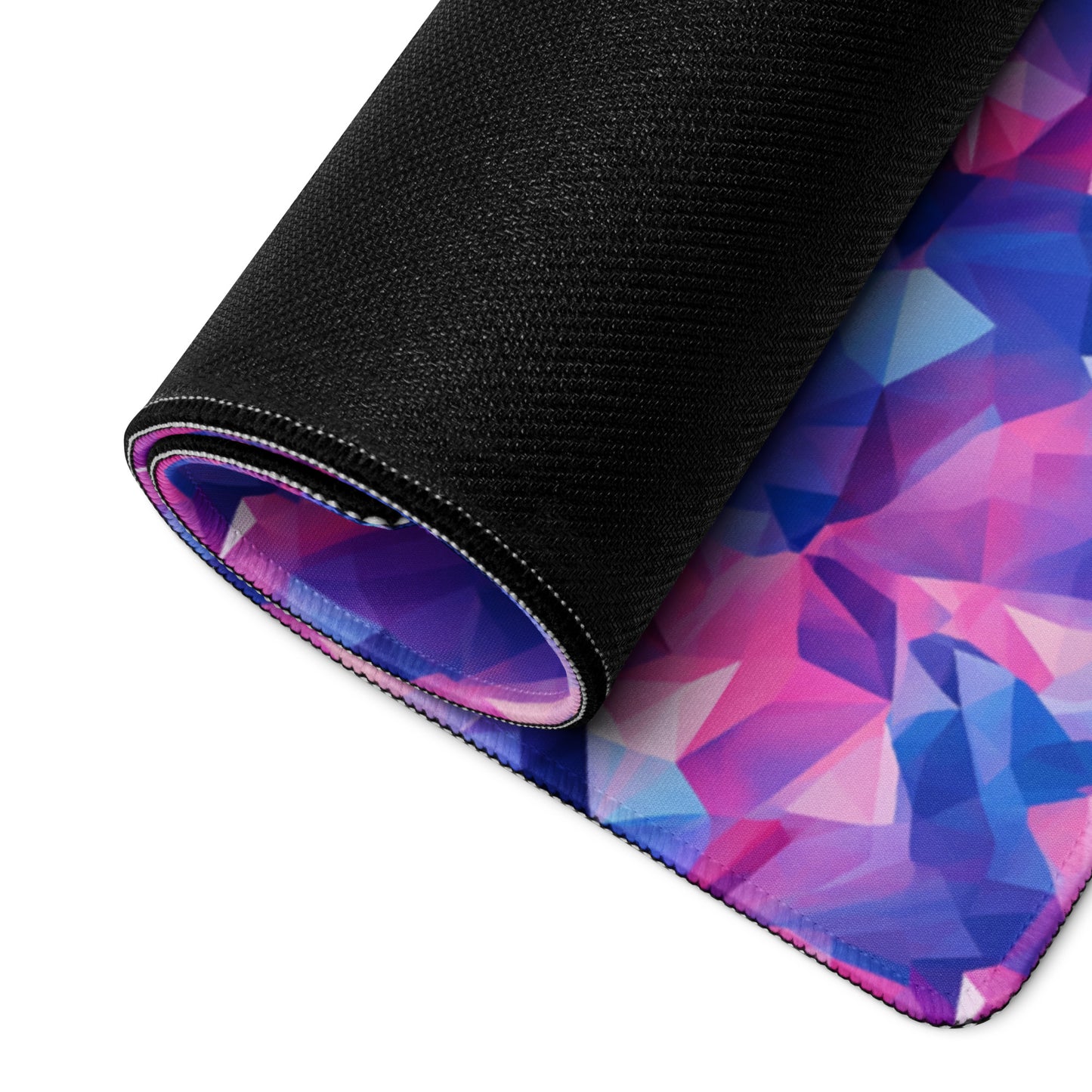 A pink and blue crystal gaming desk pad rolled up.