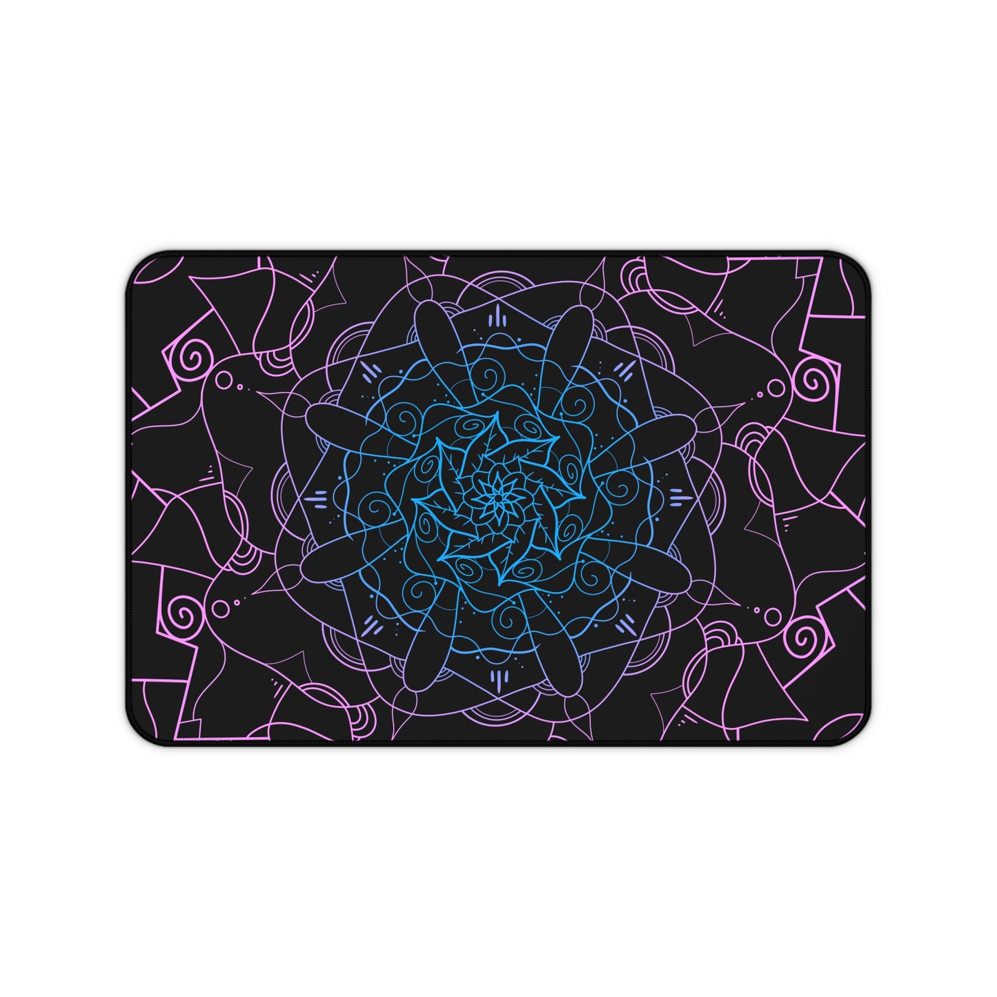 A 12" x 18" desk mat with a pink and blue mandala pattern on a black background.