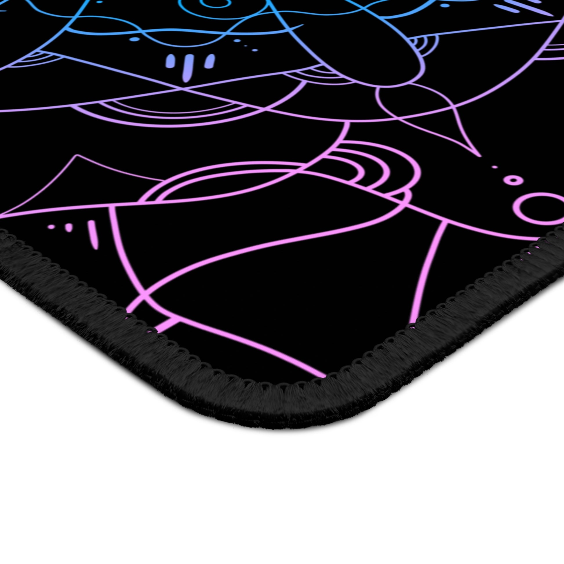 A gaming mouse pad with a pink and blue mandala pattern on a black background.
