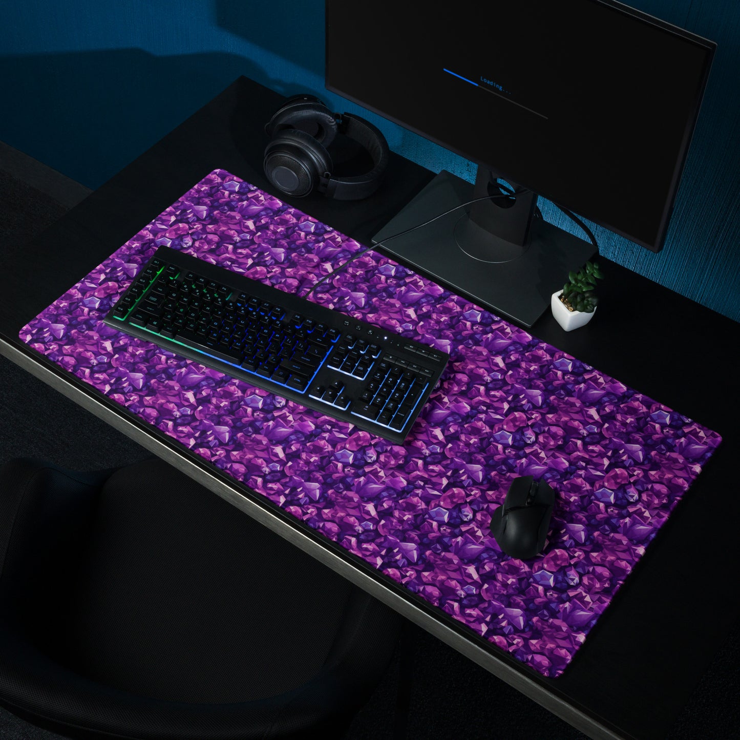A 36" x 18" gaming desk pad with purple crystals. It sits on a black desk with a monitor, keyboard, and mouse.