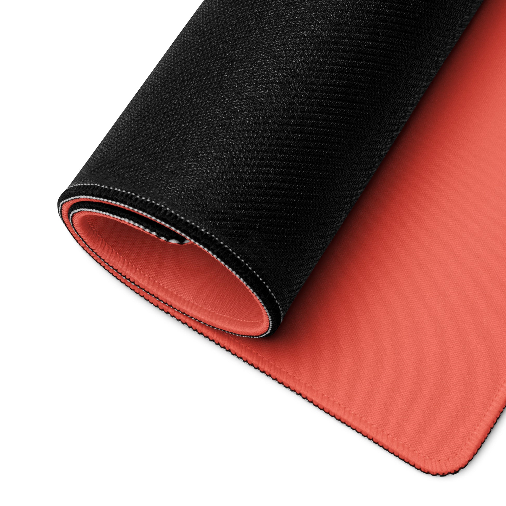 A Red 36" x 18" desk pad with cowboys dueling rolled up.