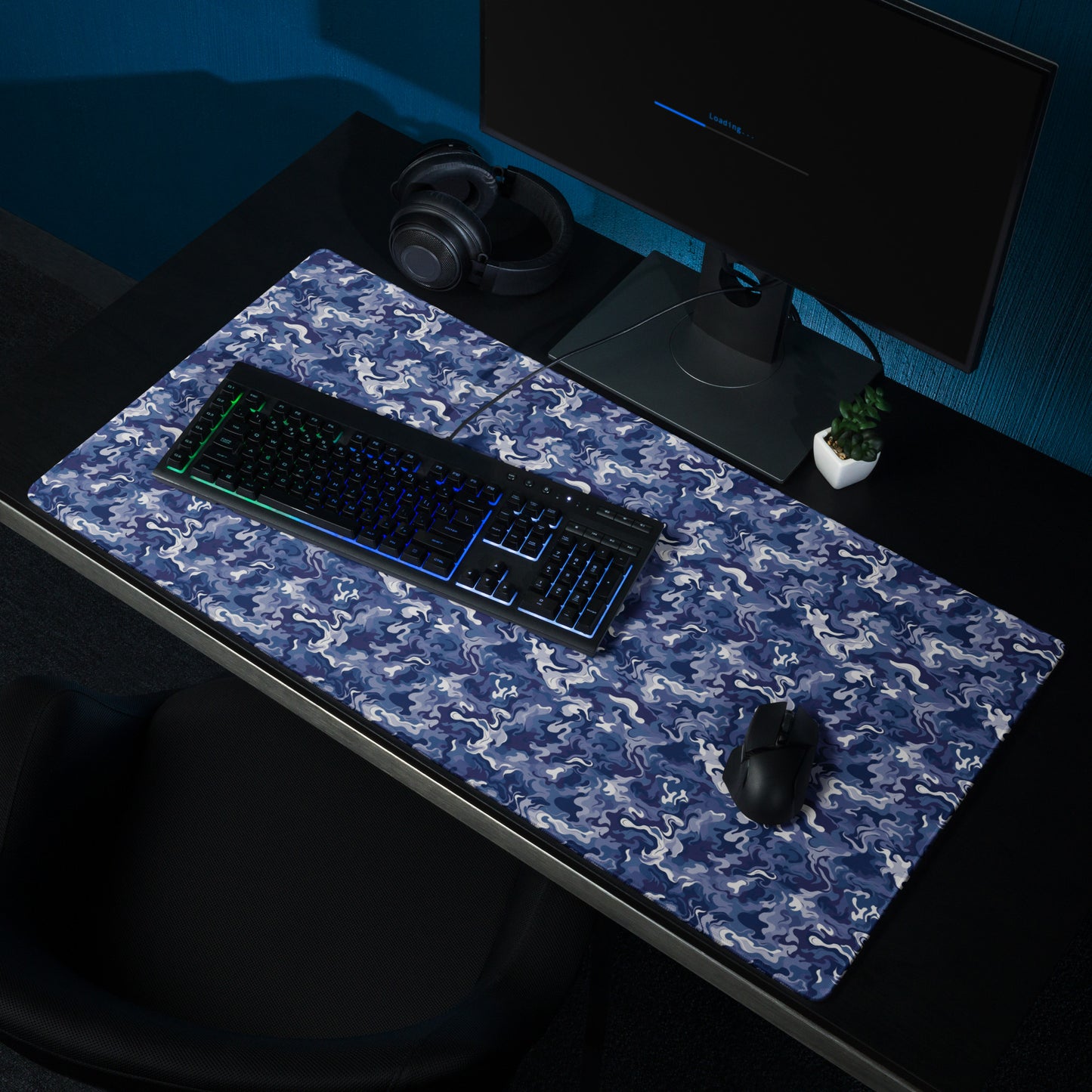 A 36" x 18" desk pad with a royal blue and white camo pattern sitting on a desk.