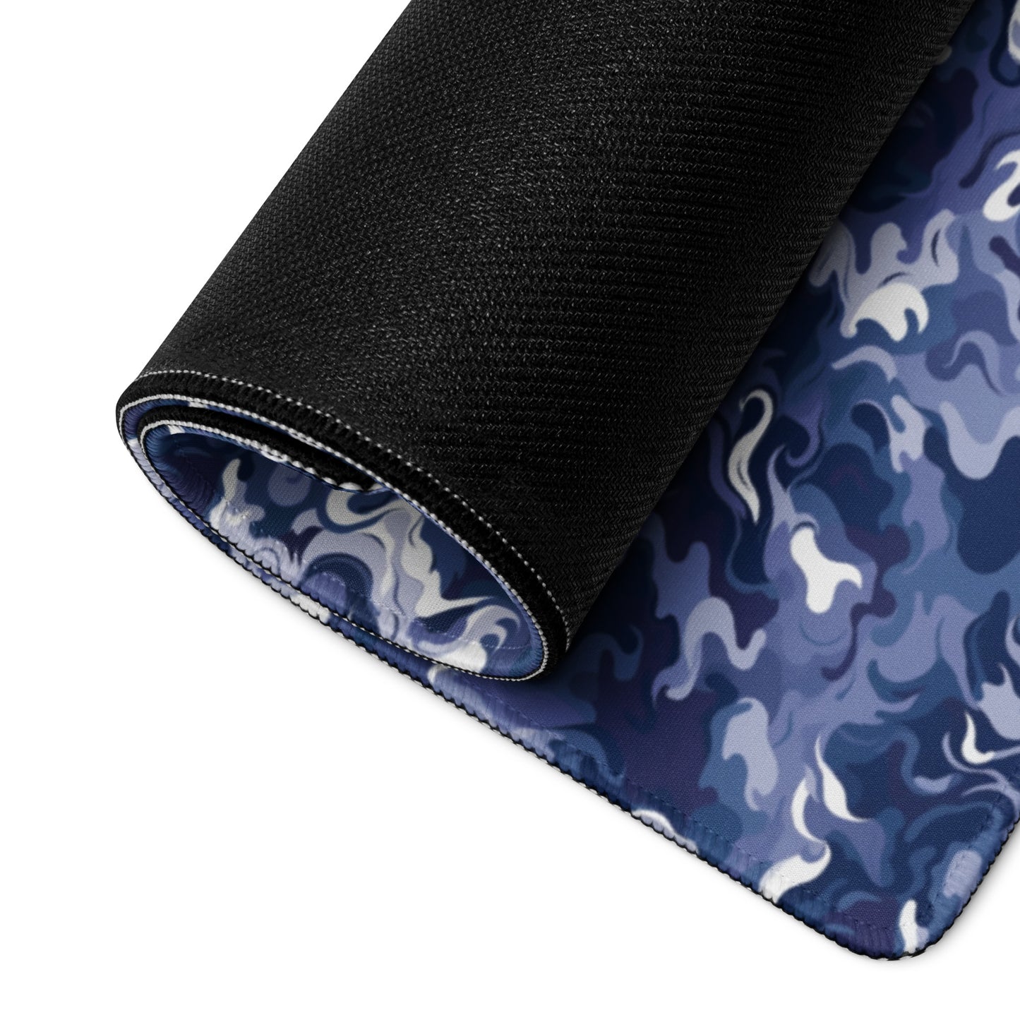 A 36" x 18" desk pad with a royal blue and white camo pattern rolled up.