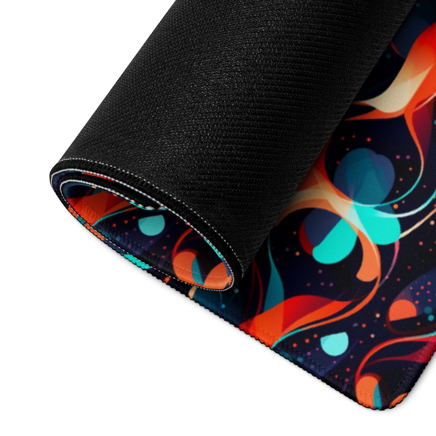 A 36" x 18" desk pad with a wavy orange and blue pattern rolled up.