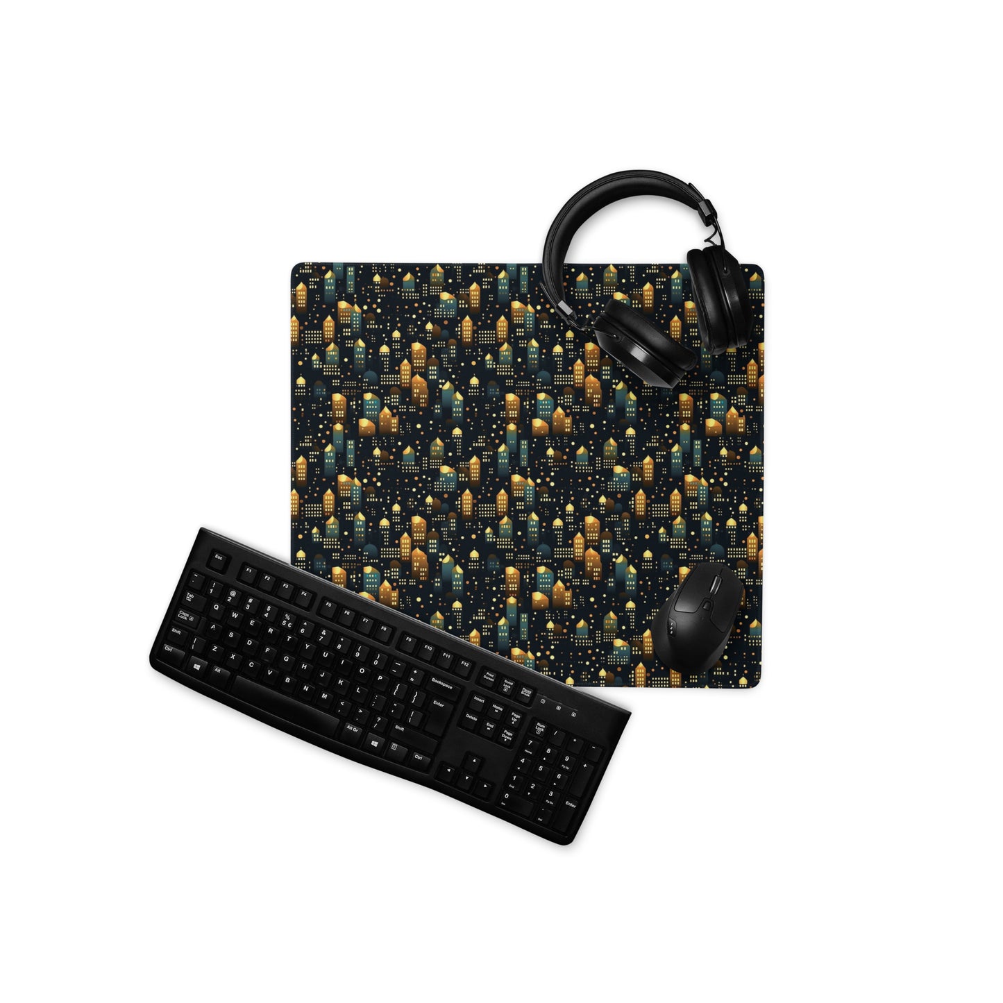 A 18" x 16" desk pad with a stary city pattern. With a keyboard, mouse, and headphones sitting on it.
