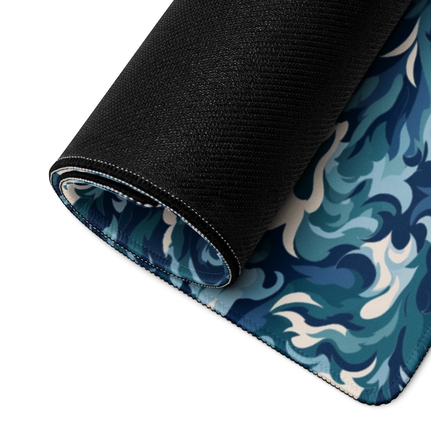 A 36" x 18" desk pad with a teal and white camo pattern rolled up.