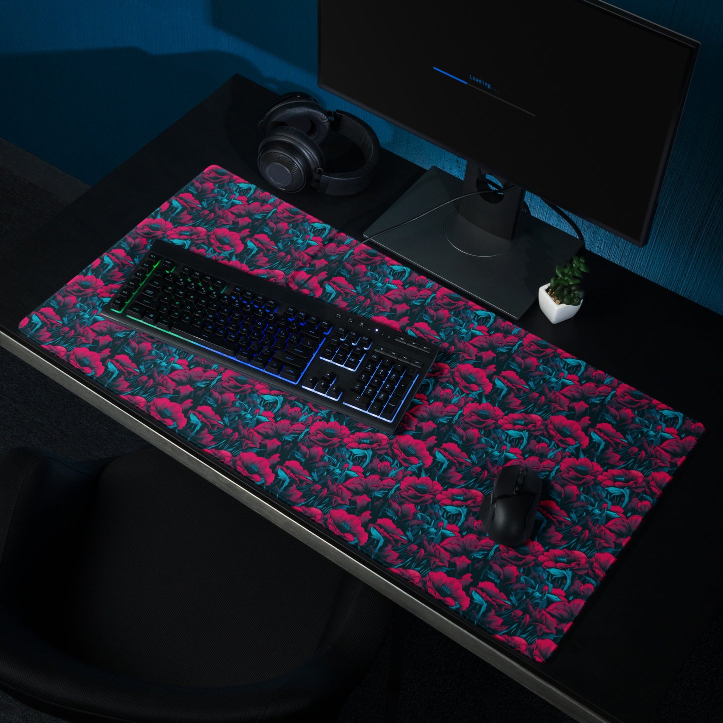 A 36" x 18" desk pad with a red and blue floral pattern sitting on a desk.