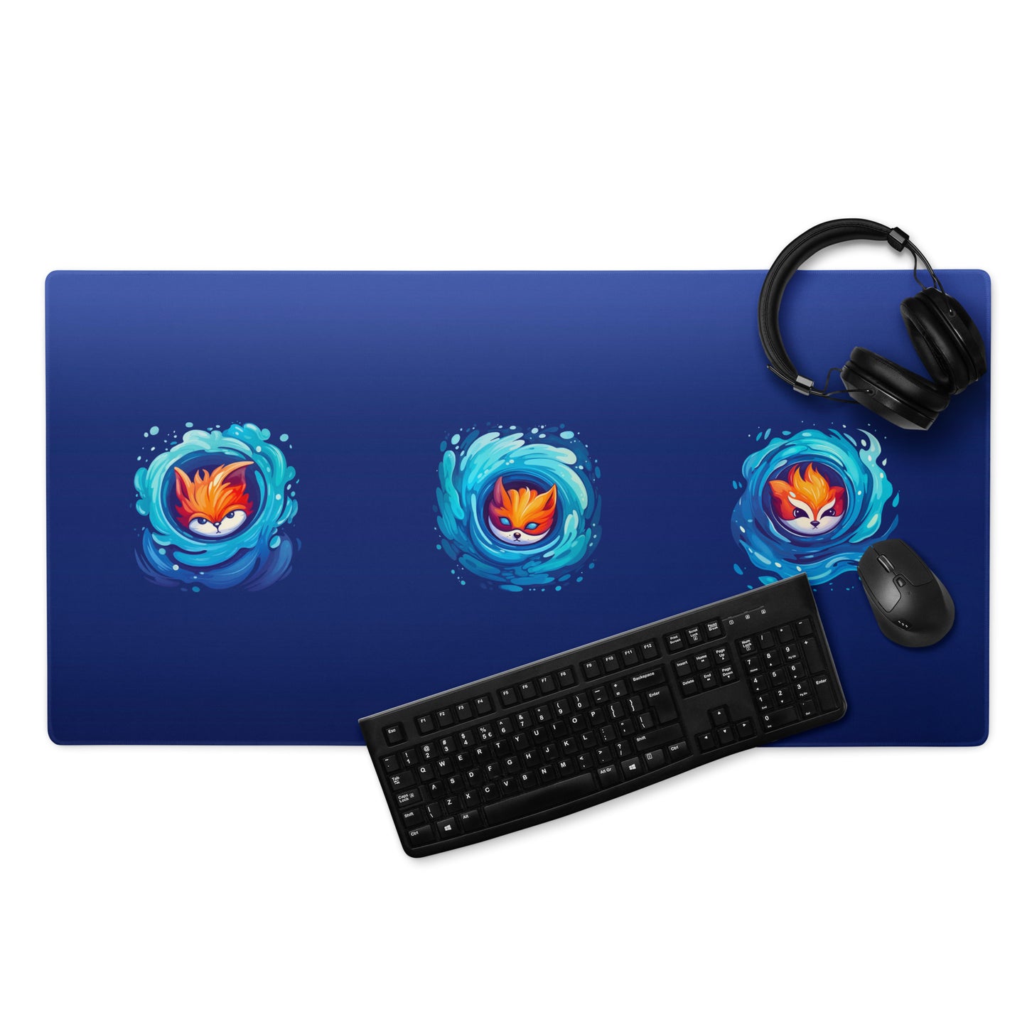 A 36" x 18" blue desk pad with three foxes in whirlpools. With a keyboard, mouse, and headphones sitting on it.