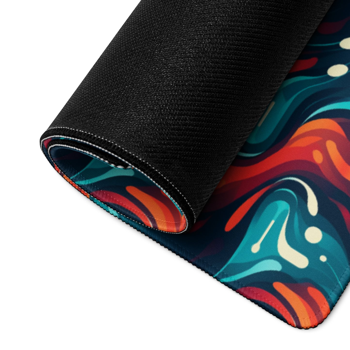 A 36" x 18" desk pad with a blue and orange wavy pattern rolled up.