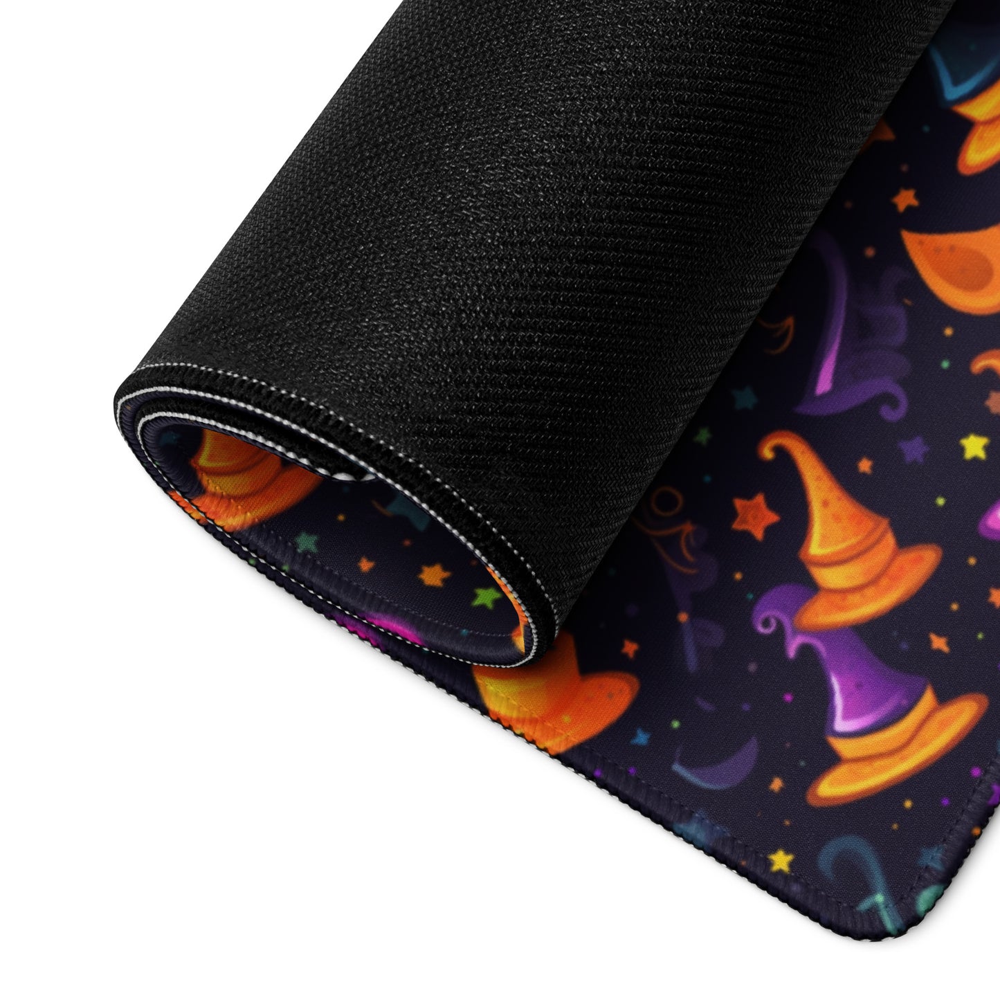 A 36" x 18" desk pad with a orange and purple wizard hat pattern rolled up.