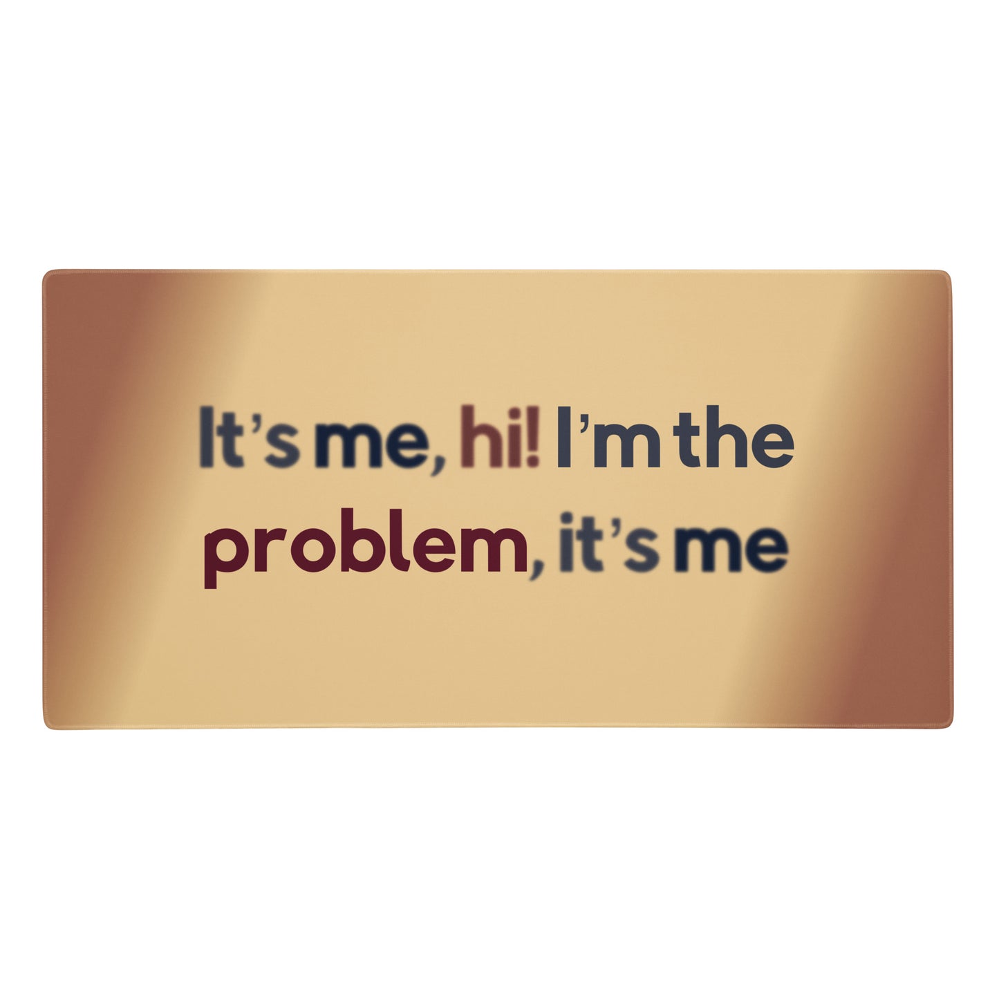A beige gaming desk pad with the quote It's me, hi! I'm the problem, it's me.