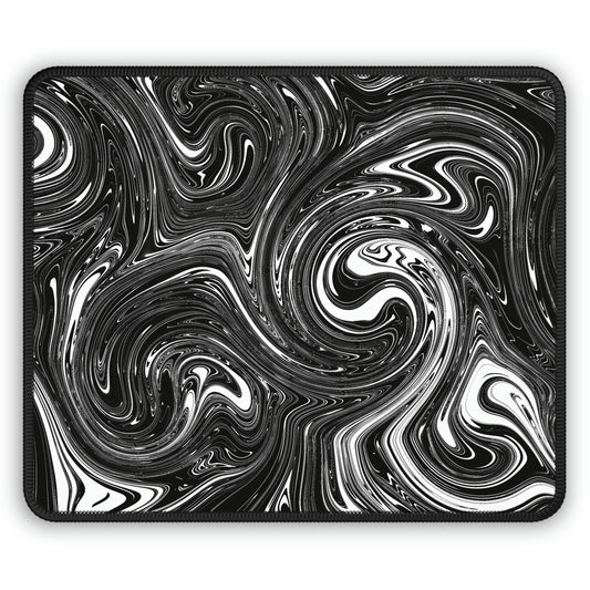 A gaming mouse pad with black and white swirls.
