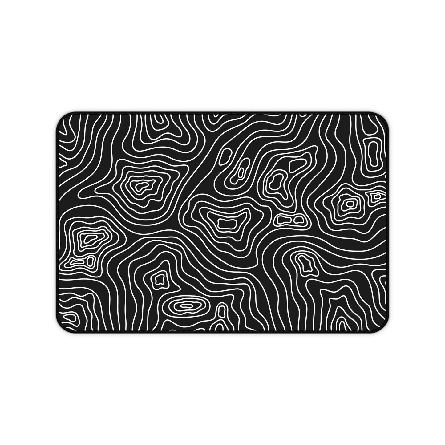 A 12" x 18" black desk mat with white topographic lines.