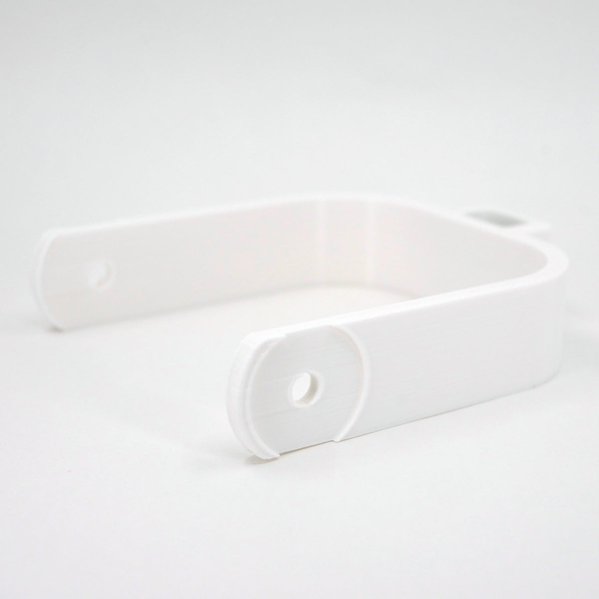 A white microphone mount for the Blue Yeti microphone.