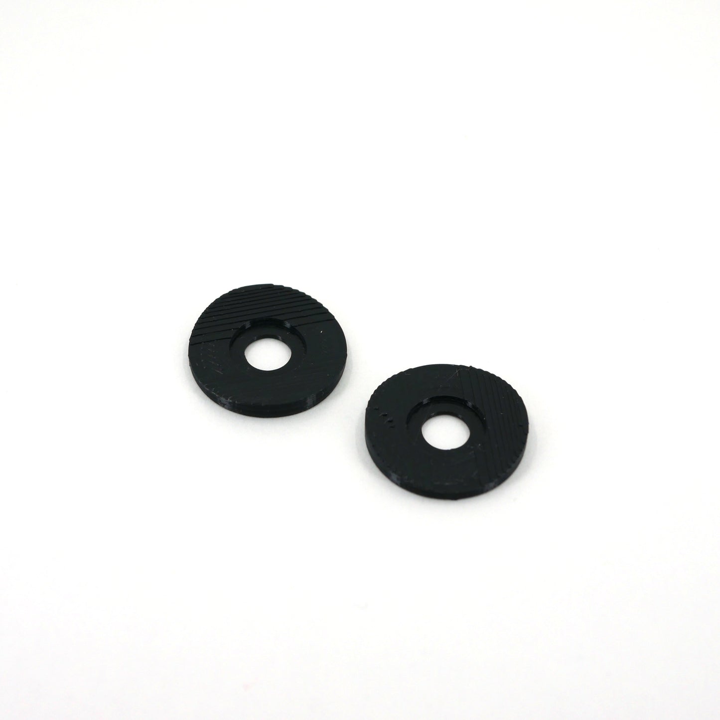 Two black microphone washers for the Blue Yeti microphone sitting at an angle.