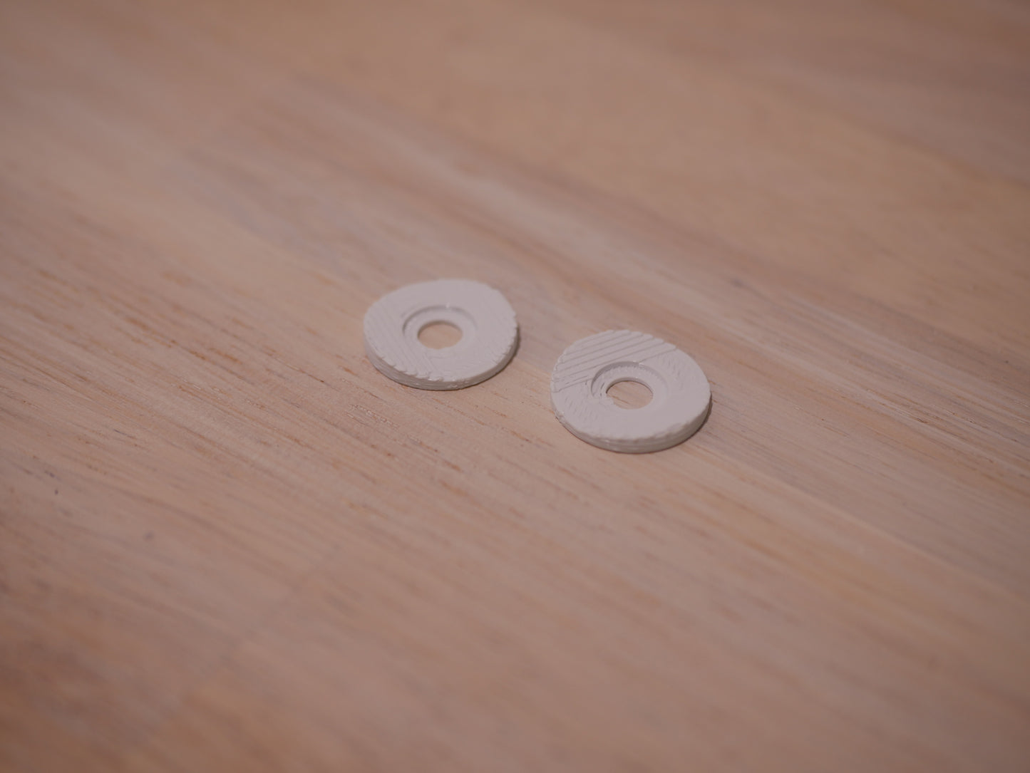 Two white microphone washers for the Blue Yeti microphone.