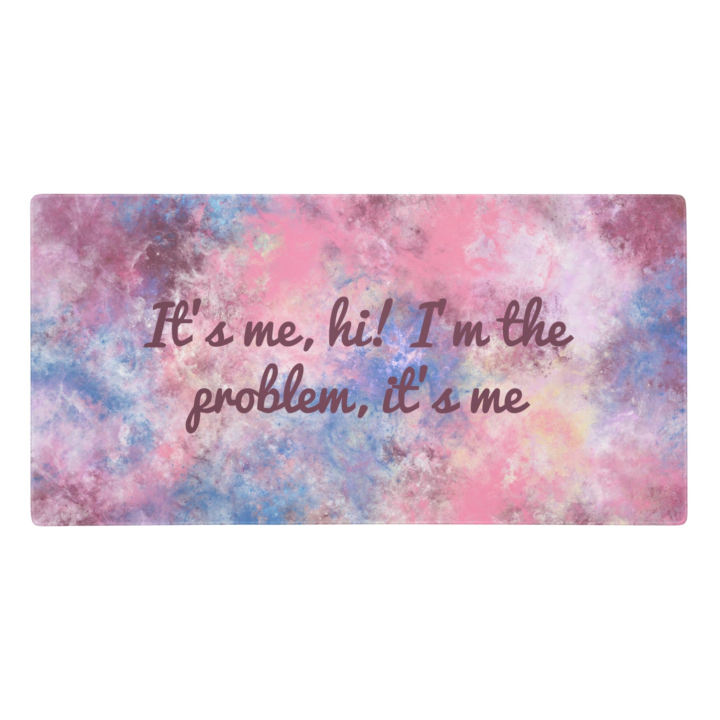 A pink, blue, and white gaming desk pad with the quote It's me, hi! I'm the problem, it's me.