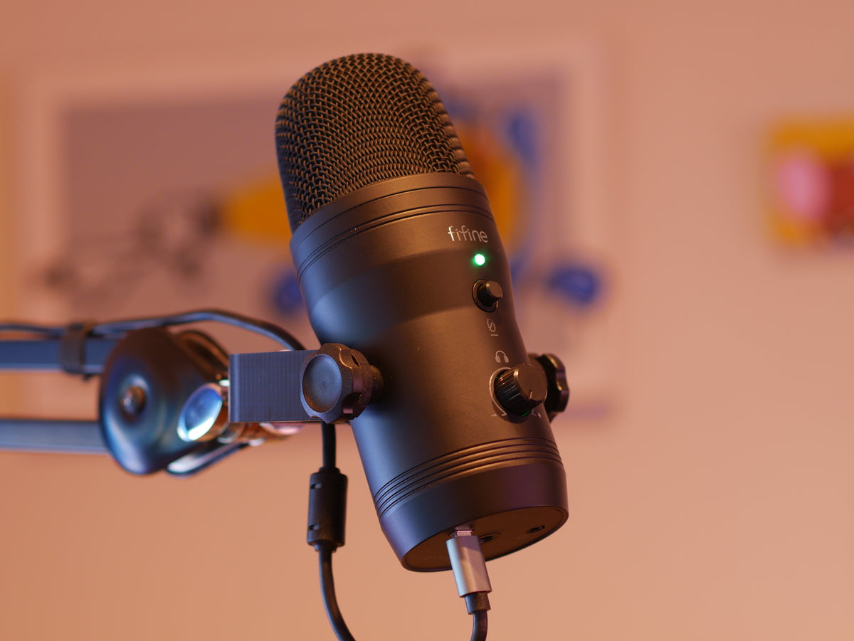 A black microphone mount attached to a boom arm and holding the FIFINE K690 microphone.