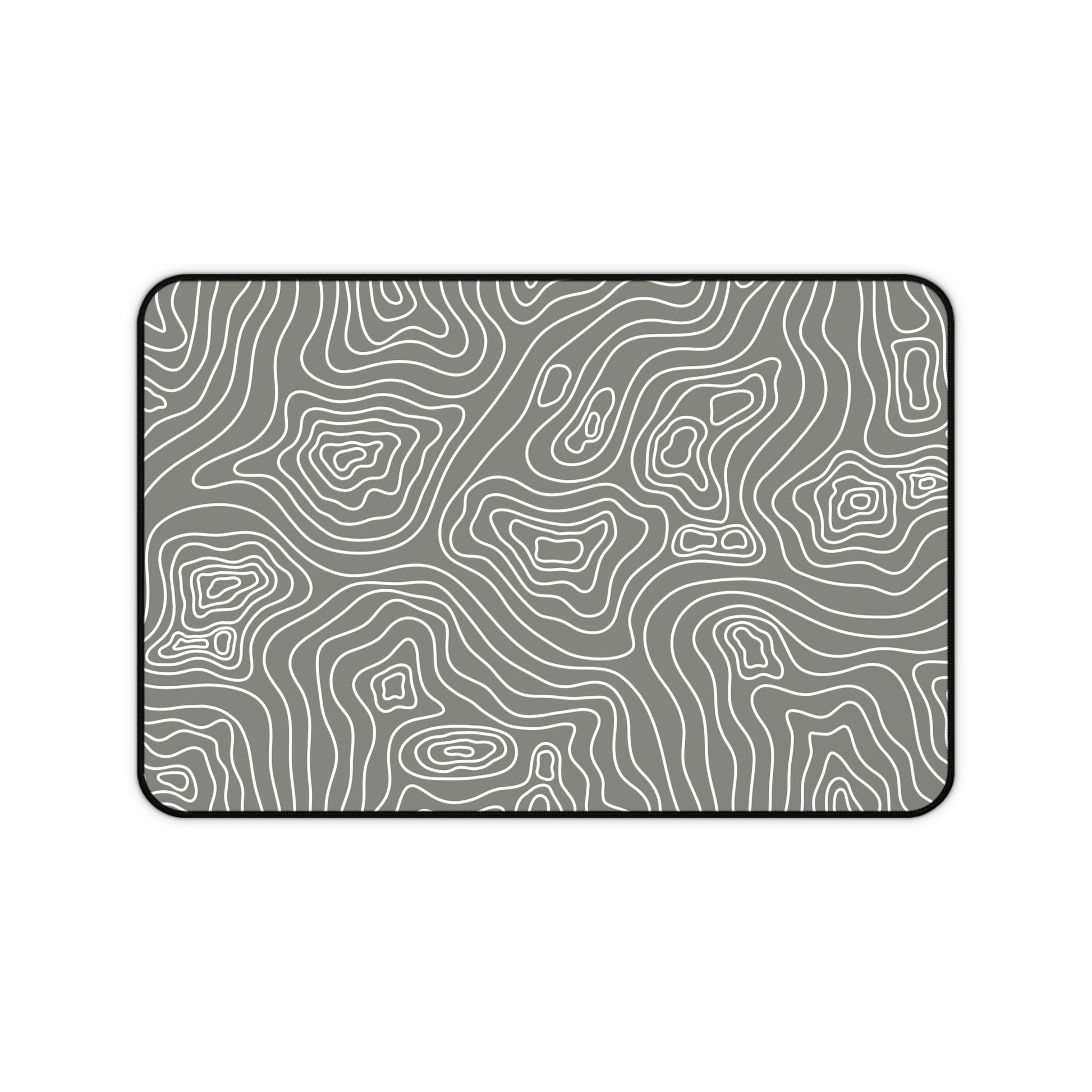 A 12" x 18" gray desk mat with white topographic lines.