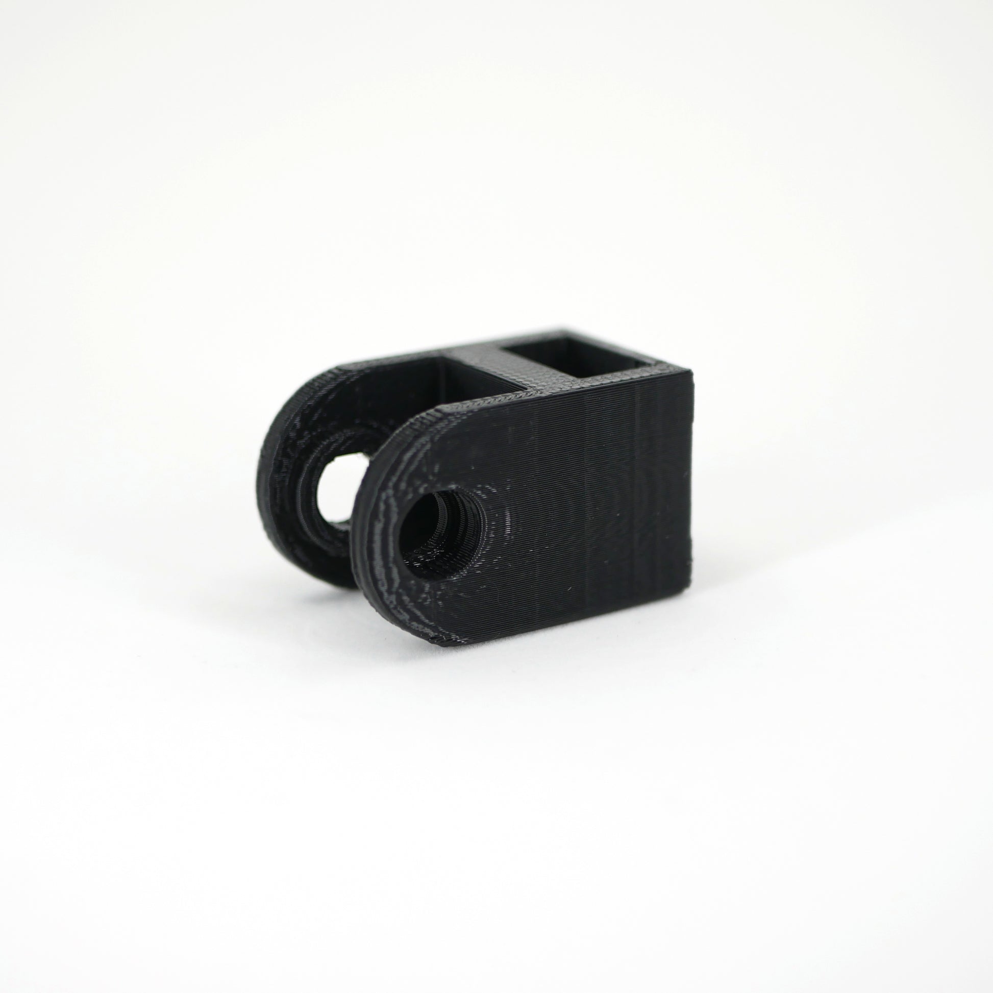 The right side of a black HyperX QuadCast microphone mount adapter.