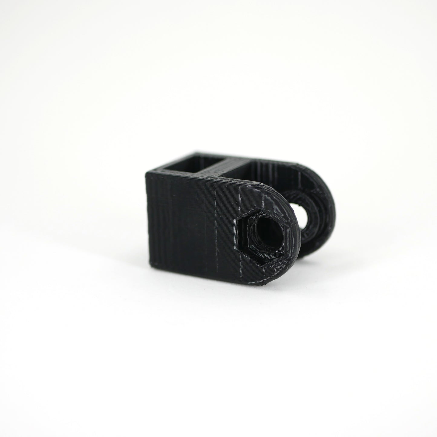 A black HyperX QuadCast microphone mount adapter.