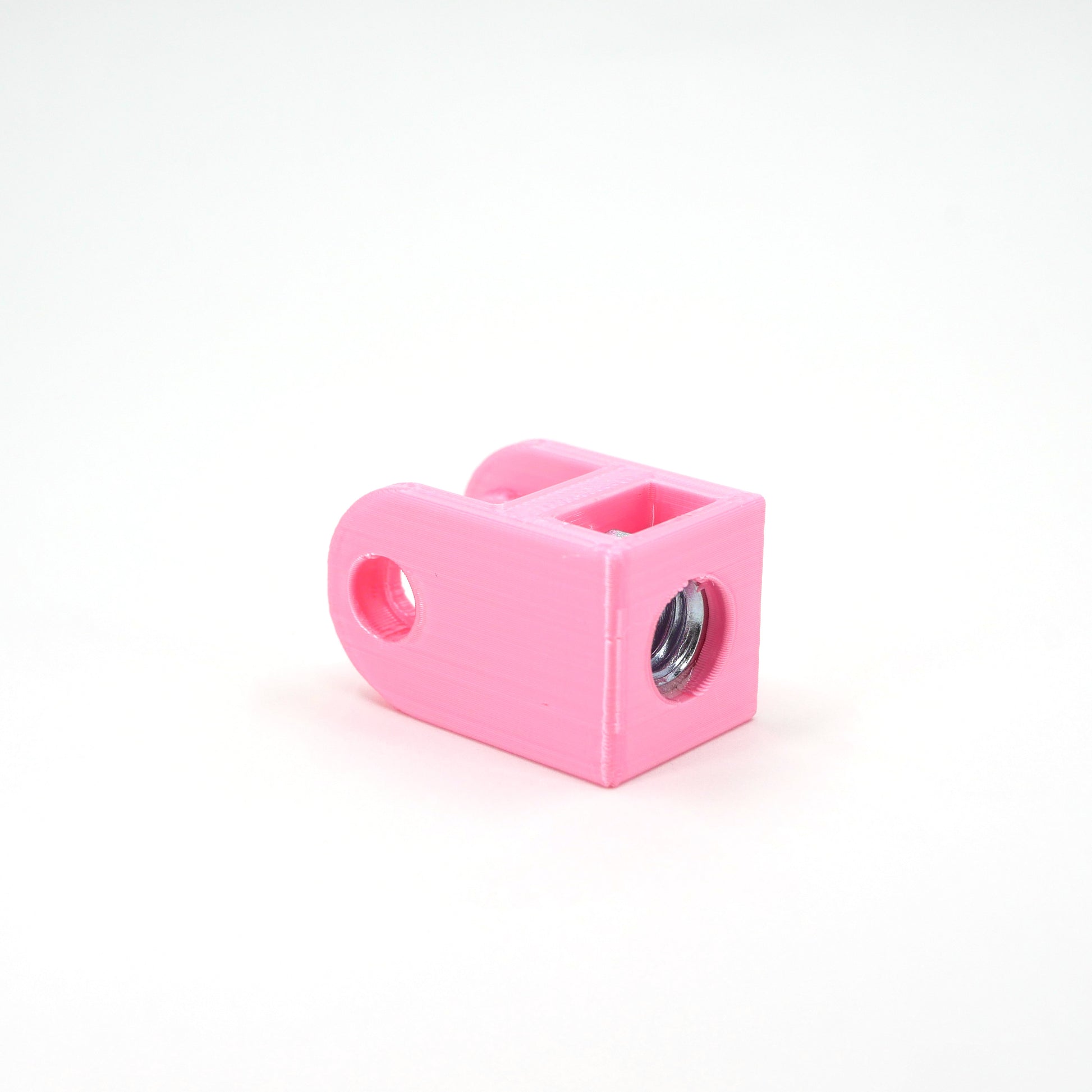 A pink HyperX QuadCast microphone mount adapter sitting at an angle.