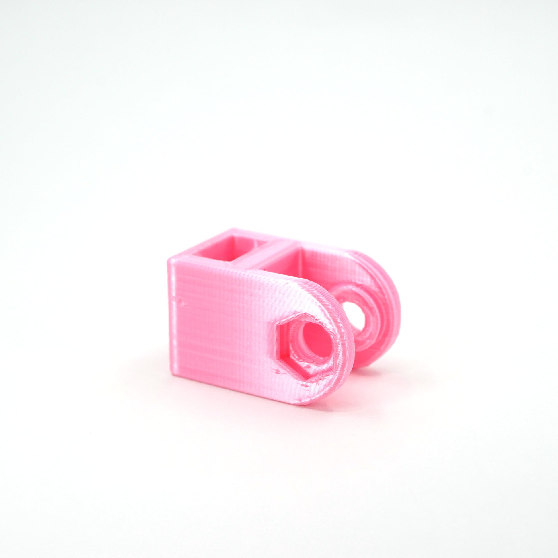 A pink HyperX QuadCast microphone mount adapter.