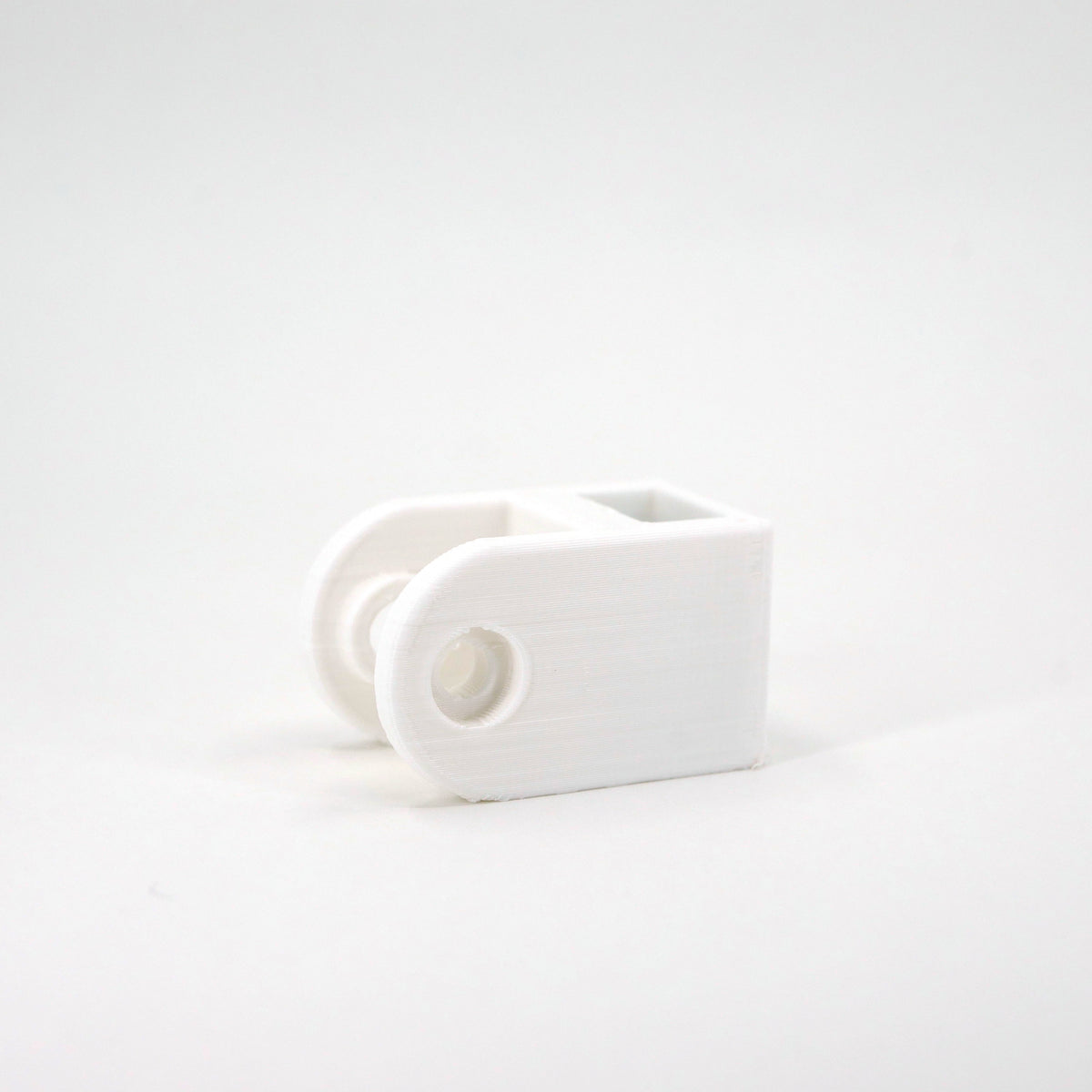 A white HyperX SoloCast microphone mount adapter.