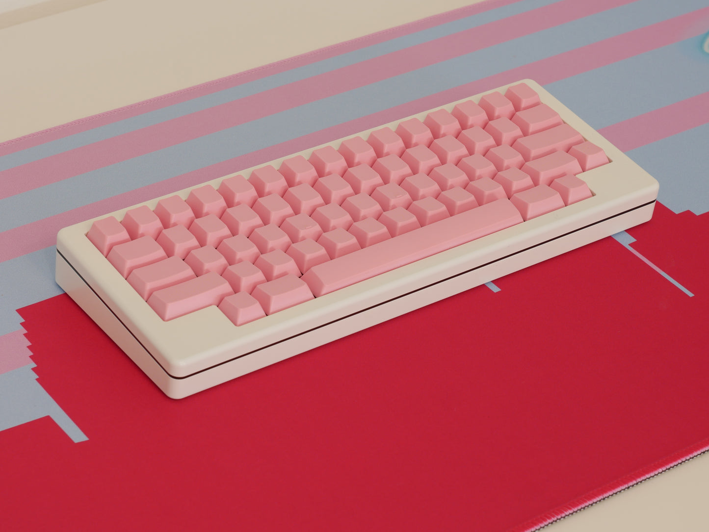 Middle of the pink and blue Miami skyline desk mat. A white keyboard with pink keycaps sits in the middle.