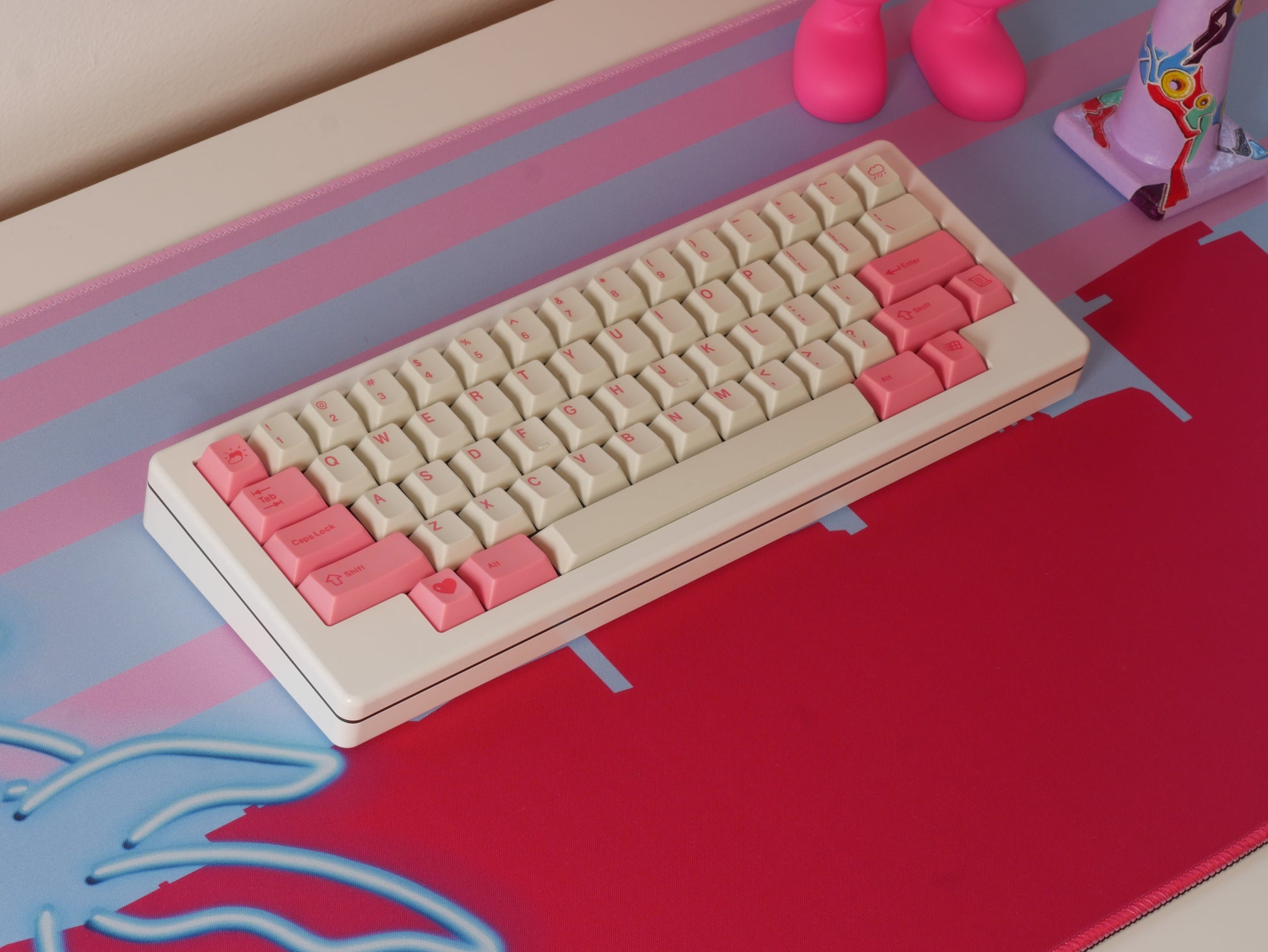 Middle of the pink and blue Miami skyline desk mat. A white keyboard with white and pink keycaps sits on it.