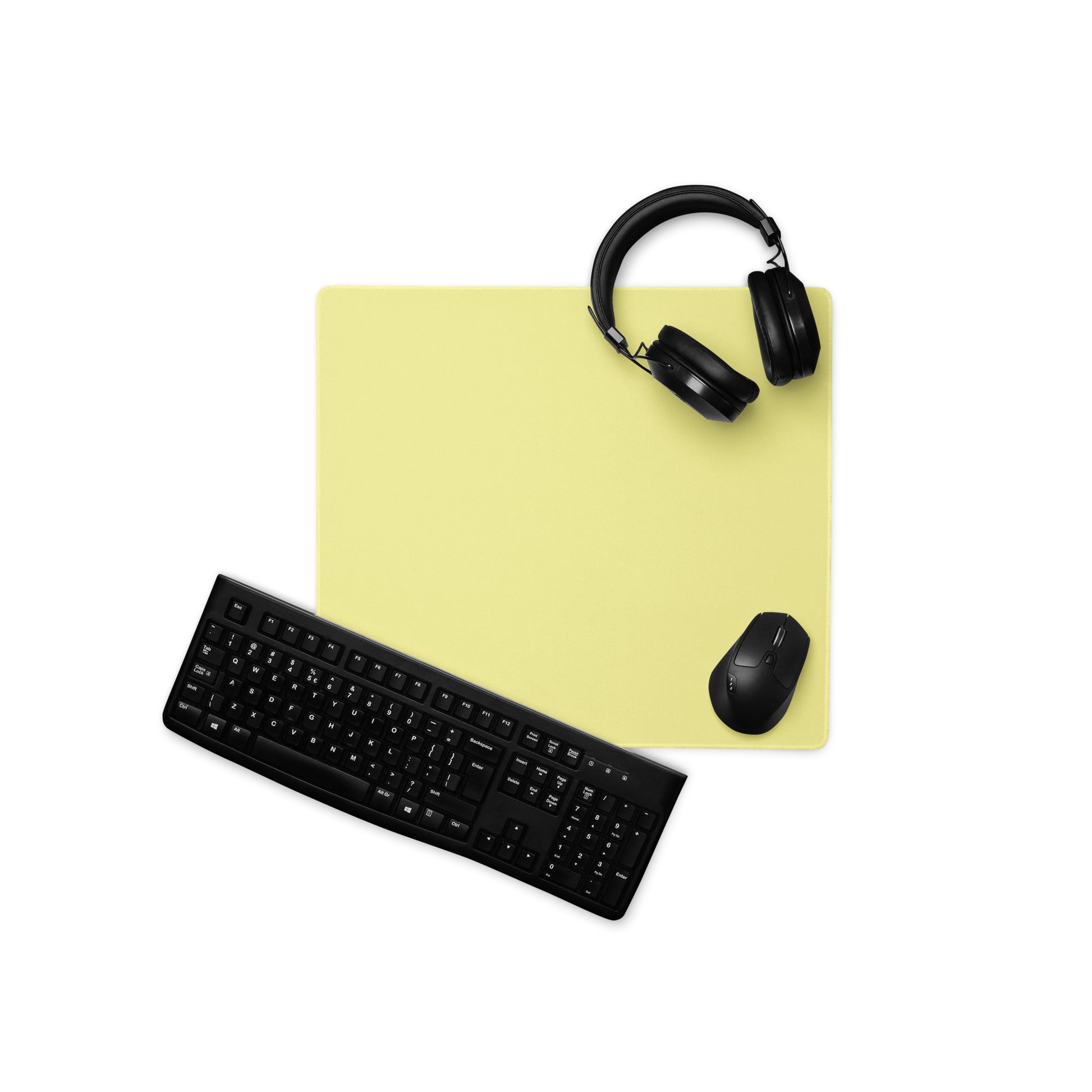 An 18" x 16" yellow gaming desk pad with a keyboard, mouse, and headphones sitting on it.